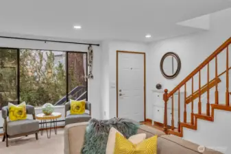 Front entry is inviting with space to hang your jacket or put your shoes.  Big picture window overlooks the outdoor green space and keeps the space light and bright.
