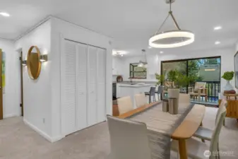 The dining room is central to the living room and kitchen. Closet can be used for coats and other items. There is a powder room left of the mirror that makes it convenient for you and your guests.