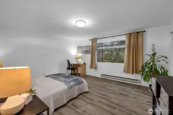 Secondary bedroom on the upper level has tons of space.  Luxury vinyl plank flooring with new lighting and baseboard trim.