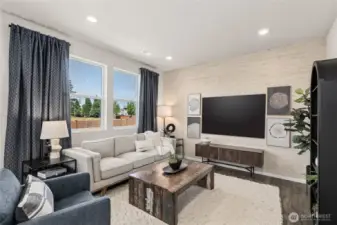 Open great room with large windows for natural light. Actual home is under construction. Colors, materials, and features may vary. See site agent for details.