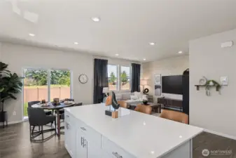 Open concept with kitchen flowing to dining, flowing to great room keeps everyone together. Actual home is under construction. Colors, materials, and features may vary. See site agent for details.