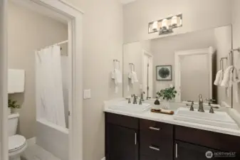 Well-appointed full bath with dual vanities and a tub/shower combo—designed for convenience and everyday functionality.