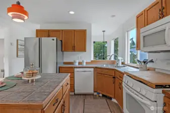 Open kitchen with easy access for everyone. Original cabinets are in great shape and can easily be painted to create your own look.