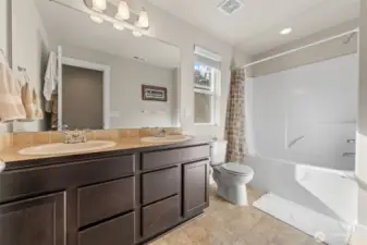 Upstairs Shared Bathroom – Features a double-sink vanity for added convenience.