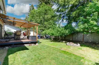 Side view of the back yard.  Fire pit to the right.