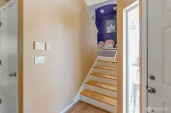 Stairs to the upper level has a seating nook, perfect for a place to read.