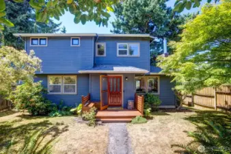 Inviting porch and fenced yard welcome you in