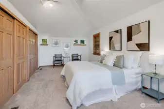 Primary suite upstairs with wall of closets, a 5 piece bath, and it's own private deck