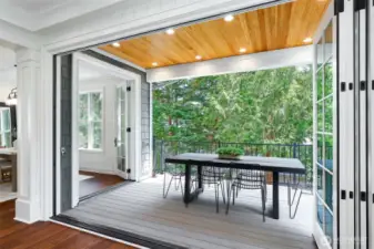 Folding glass doors that open out to to the deck