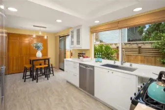 Bright white cabinetry and quartz counter tops grace the nicely updated kitchen, complete with gas stove.  Paved patio on this side of the yard too, fully fenced!