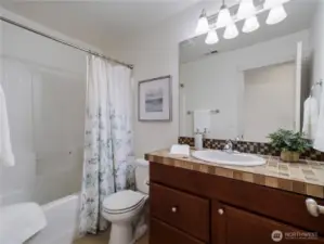 Hall bathroom with extended vanity counter space.