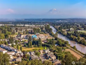 Mount Rainier and the Cascade foothills can be seen off in the distance.