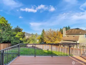 Expansive trex deck with Cascade views and lawn.