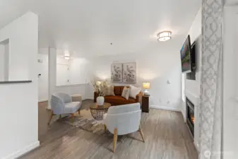 Living Room with defined entry, updated light fixtures, new paint and flooring