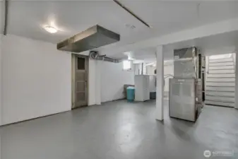 Lower-level laundry, utility, and storage room. If used as multi-family, space can be easily configured for shared laundry access.