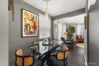 A beautiful statement light fixture hangs from the ceiling, enhancing the dining area with style and warmth.