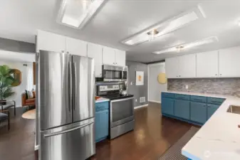 Stainless steel appliances include a 3 door fridge/freezer and smooth top electric range with built-in microwave oven complete the updated kitchen, perfectly blending style and functionality.