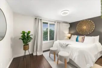 A spacious bedroom highlighted by a stylish accent wall and a modern mini-split system for year-round comfort.