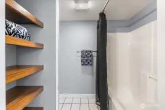 Charming wood decorative shelving adds both storage and character to the bathroom.