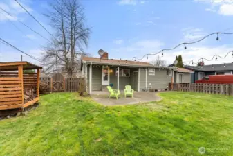A dedicated wood storage structure keeps firewood organized and ready for the wood-burning fireplace.