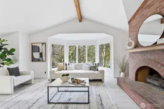 The living room has a gas fireplace and garden windows that look out to the front yard.