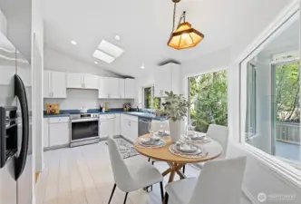 The kitchen has cathedral ceilings, skylights and big windows facing the back yard.