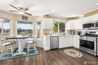 Timeless kitchen with white cabinets and newer stainless steel appliances