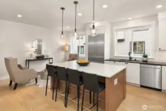 Seamless connection between kitchen, dining, and living areas enhances the home’s open layout.
