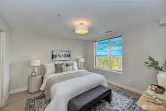Wake up to breathtaking Puget Sound and mountain views in this primary suite, complete with a full bath featuring a double vanity and a generous walk-in closet.