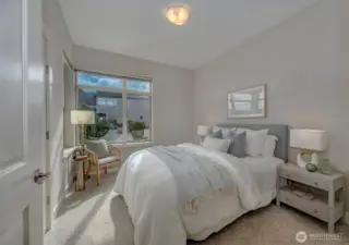 Guest bedroom is light filled and spacious with a large walk-in closet.