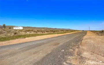 View from South West corner of property looking down driveway and fence line.