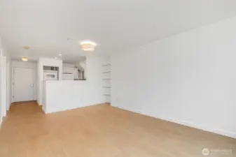 Without the virtual staging. The first level is a large living room space with room for dining table, art on the walls and more!