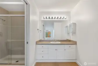 Large vanity and fully tiled shower.