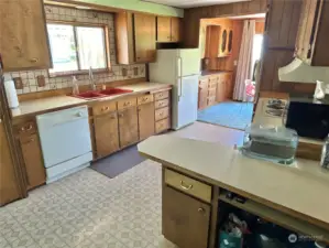 Kitchen opens into dining room with built in china cabinet.