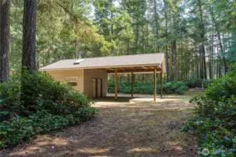 A good view of the carport with skylighted 3/4 baths behind.
