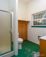 Shower and toilet in bathroom through the door on the right.