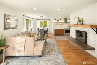 Large combination living room dining room and original wood burning fireplace.