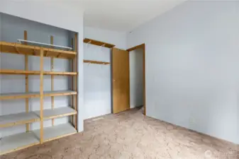 Third bedroom with built in shelving in closet