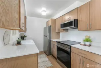 All new oak cabinetry, and appliances - induction glass top range, microwave and Refrigerator