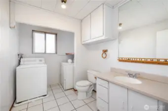 Downstairs laundry room complete with storage and 1/2 bathroom.