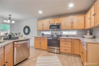 The kitchen is appointed with maple cabinetry ,granite countertops, and stainless steel appliances, blending style  with functionality.