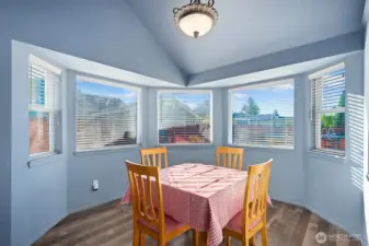 Dining room features bay windows overlooking the back yard.