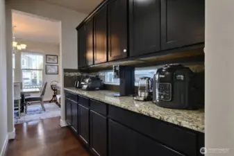 Butler's Pantry between dining room and kitchen. Ample counter space, cabinets and outlets for all countertop appliances. An organizational dream! Walk in Pantry located to the left.