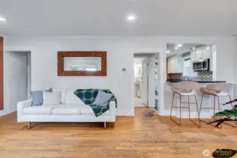 Bright living room opens to dining area and kitchen with a convenient bar
