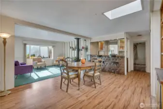 Open living & dining room with bar has new carpet & new laminate floors ~