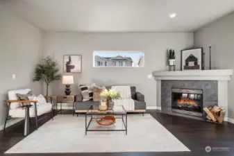 Living room on main floor just off the kitchen with gas fireplace and plenty of natural light