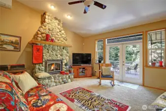 Vaulted Great room is flooded with natural light and boasts wooded territorial and western sunset views