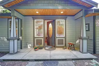 Front door with leaded glass lights. Wide covered porch entry.