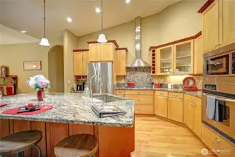 Richly grained granite counters top well-designed  with drawers for easy access. high end appliances include new 5 burner cooktop, French door refrigerator, wall oven and microwave unit. Dining island offers additional prep surfaces and dining space.