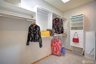 Dressing room walk-through closet with built-in components adjoins the primary suite